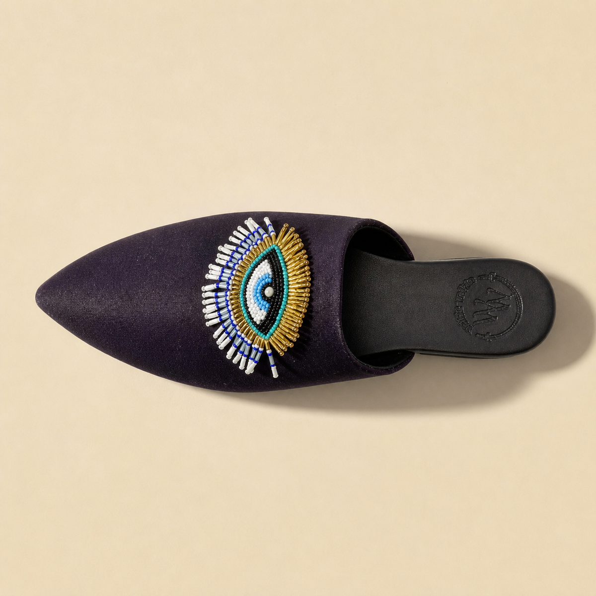 Top-down view of the Walkie Walkie Eclipse navy organza mule and its beaded evil eye